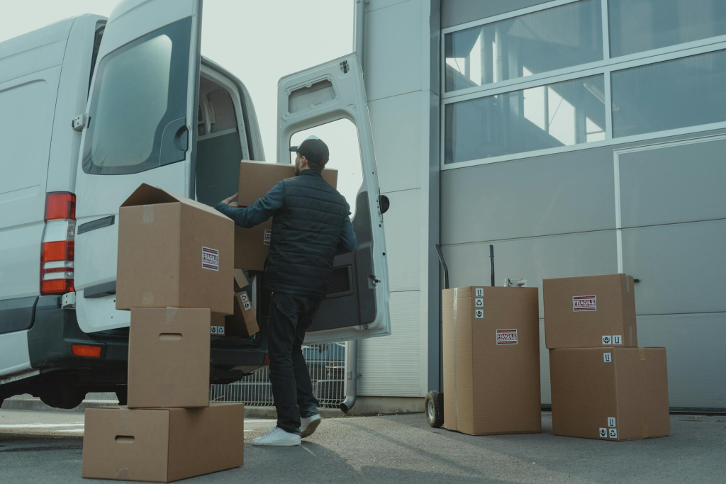 Delivery driver loading groceries into a car for gig work